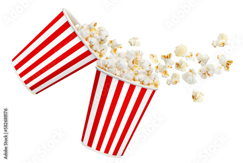 Delicious popcorn flying out of red striped carton cups, cut out