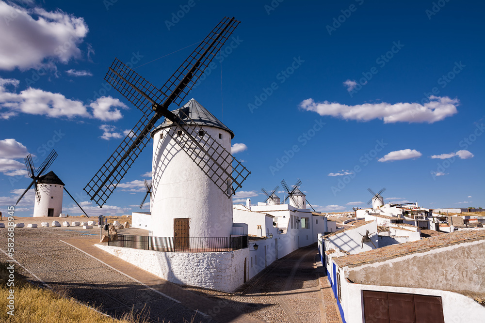 Ancient windmills near houses in Campo de Criptana, Spain, defined in Cervantes' Don Quixote 