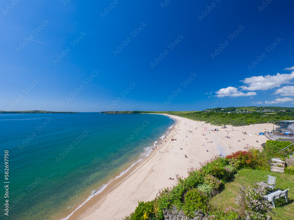 White sandy beach on a sunny day (Tenby, Wales, United Kingdom, in summer) White sandy beach on a sunny day (Tenby, Wales, United Kingdom, in summer)