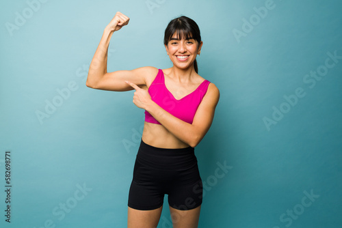Strong fitness woman doing a bicep curl