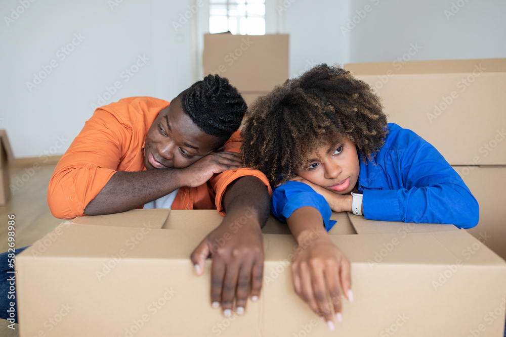Moving Stress. Black Couple Feeling Tired While Relocating Home Moving Stress. Black Couple Feeling Tired While Relocating Home