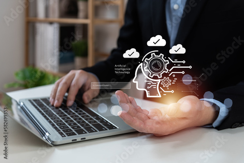 Businessman using laptop connecting to cloud computing concept, AI (artificial intelligence), business global internet technology and digital marketing, chatbot with AI, command prompt, quantum. photo