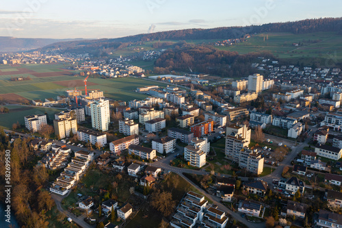 Drone snapshot over a small village with a river called Limmat on a spring morning.