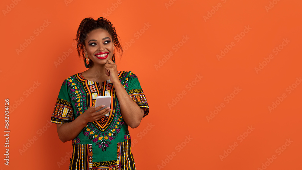 Curious traditional african woman using cell phone, copy space