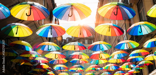 Street with umbrellas in LGBT colors for gay pride day photo