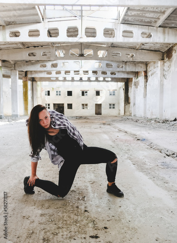 Girl dancing hip-hop in old industrial building. Young girl art dance. Street urban lifestyle.