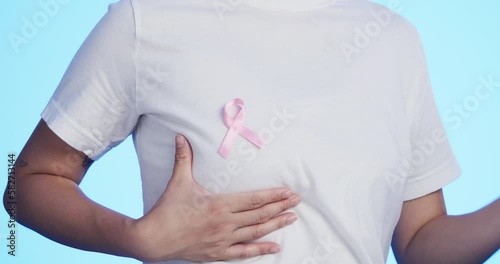 Wallpaper Mural Pink ribbon, breast cancer and medical with a man in studio on a blue background for health. Chest, awareness and healthcare with a male placing a bow, symbol or sign of recognition in October Torontodigital.ca