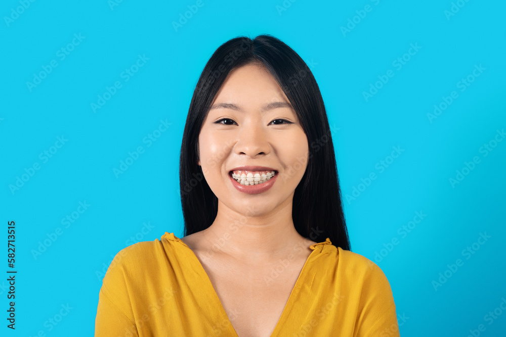 Beautiful asian woman posing over blue background Beautiful asian woman posing over blue background