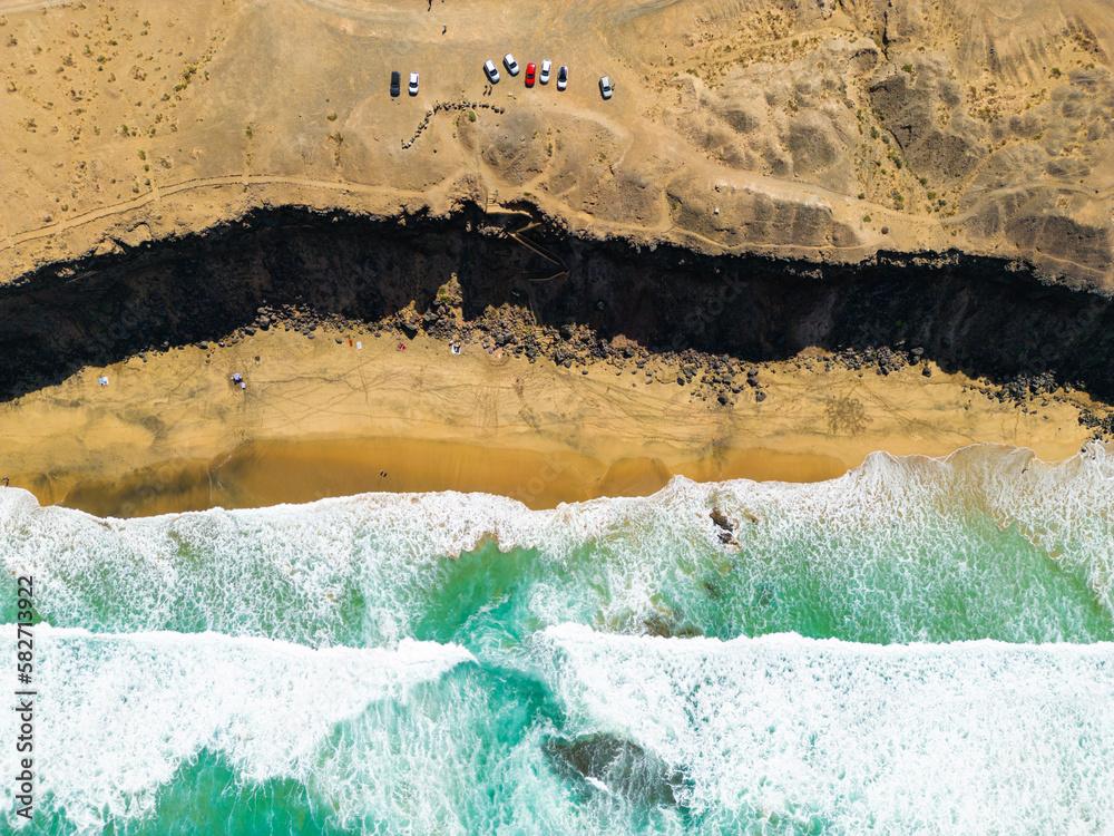 Aerial high level top down bird’s eye view of the rocky cliffs and beaches near El Cotillo in Fuerteventura Spain