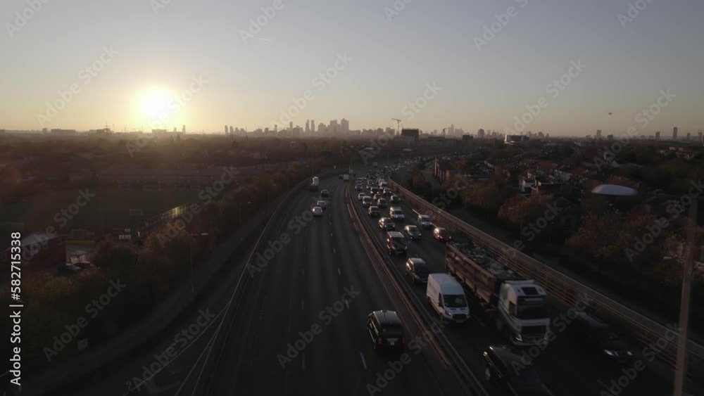 Elevated trunk road and silhouettes of skyscrapers against sunset sky Elevated trunk road and silhouettes of skyscrapers against sunset sky