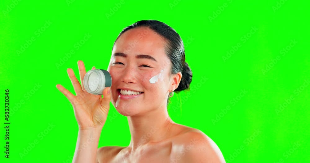 Face, skincare and woman with cream container on green screen in studio on background. Dermatology, cosmetics portrait and happy Asian female model with product, lotion or moisturizer for skin beauty Face, skincare and woman with cream container on green screen in studio on background. Dermatology, cosmetics portrait and happy Asian female model with product, lotion or moisturizer for skin beauty