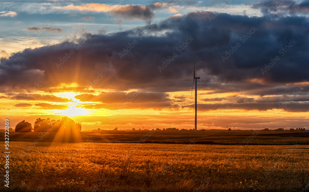 Windmill in Nature. Blurry Cloudy Sky. Long Exposure. Beautiful Nature. Sunset Light. Windmill in Nature. Blurry Cloudy Sky. Long Exposure. Beautiful Nature. Sunset Light.