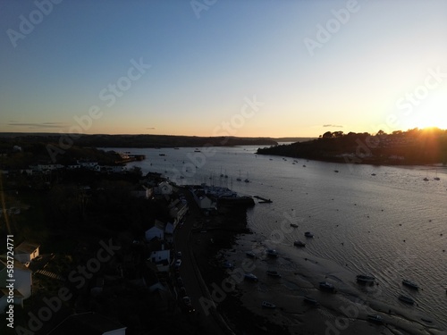 Coast at sunset, final light over the harbour, boats and river estuary