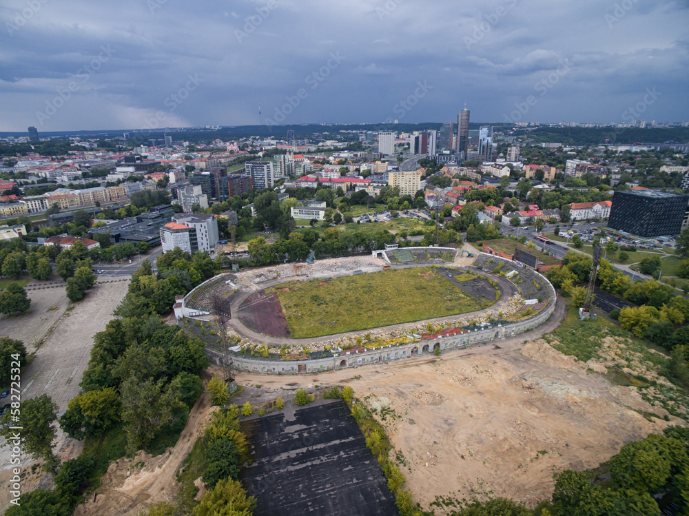 VILNIUS, LITHUANIA - JULY 11, 2016: Flying over the Vilnius and Stadium of Zalgiris. Cityscape in Background