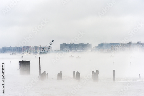 Hudson river in Winter with Misty Edgewater Cityscape in Background. New Jersey, USA © Mindaugas Dulinskas
