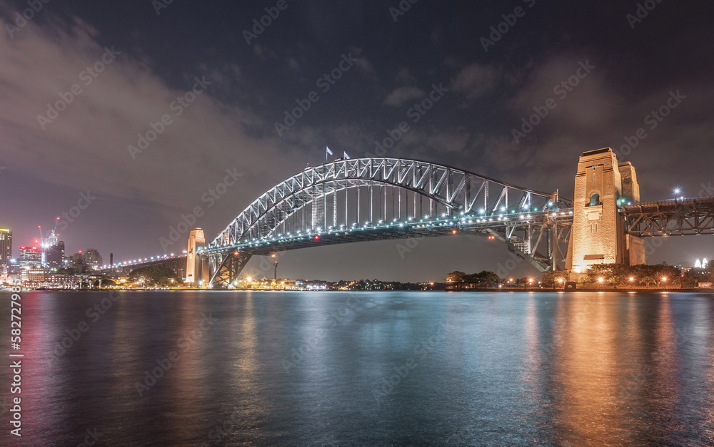 Naklejka premium Sydney Harbour Bridge at Night. Long Exposure. Flowing Sky. Australia