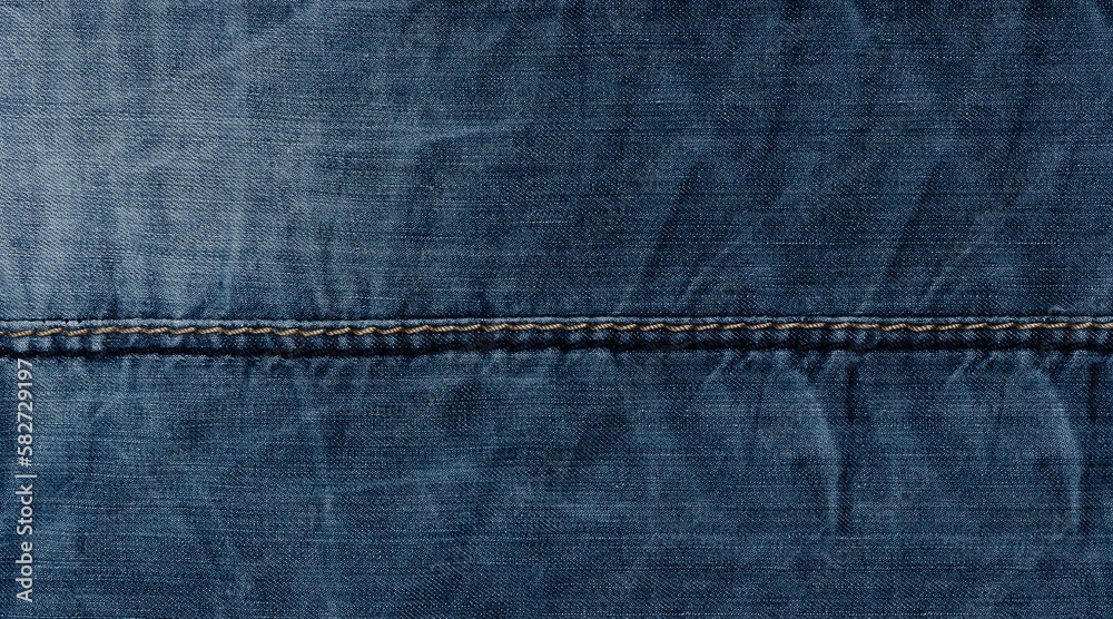 Naklejka premium Widescreen denim surface texture with stitching and folds