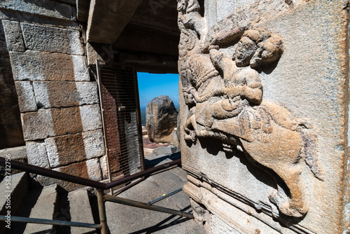 Beautiful stone carving of a hero figure on a pillar of the ancient Jain temple on Vindhyagiri hill in Shravanabelagola in Karnataka. photo