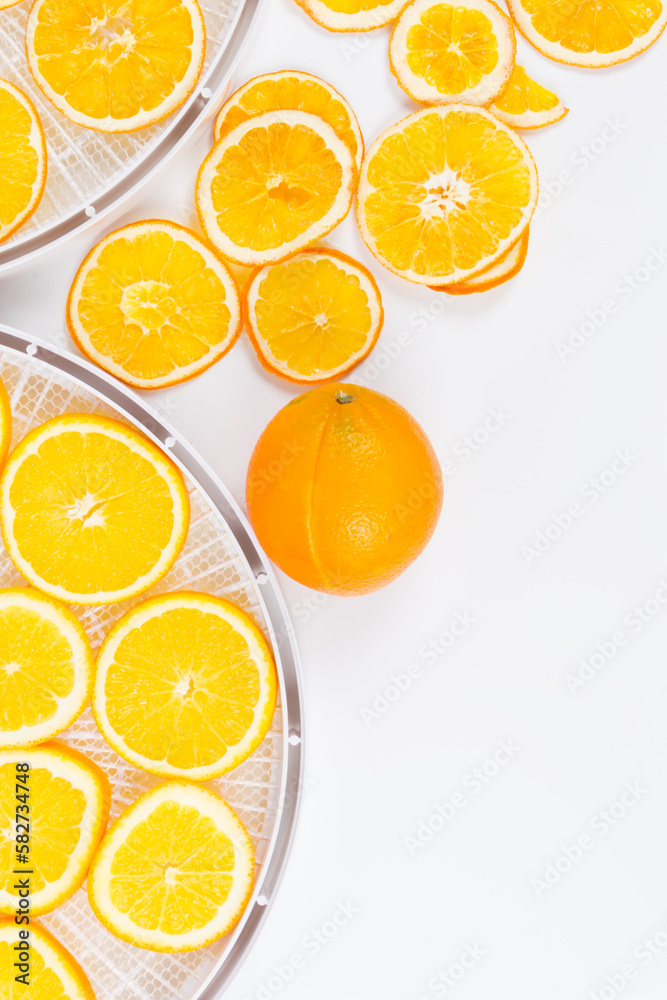 there is a sliced orange on a white round grate for further drying, there is a place for the inscription there is a sliced orange on a white round grate for further drying, there is a place for the inscription