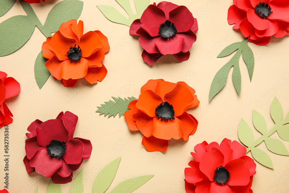 Fototapeta premium Paper poppy flowers with leaves on beige background