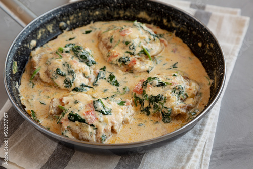 Homemade Creamy Tuscan Chicken with Spinach in a Pan, side view.