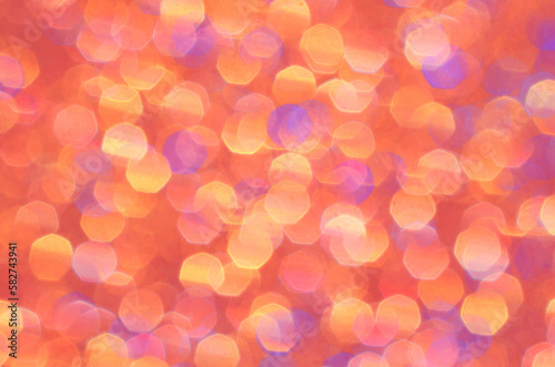 Orange, yellow, gold and purple abstract background. Bright sparkle and glow of brilliant color for festive backdrop. Beautiful pastel pattern, cheerful glowing colors.
