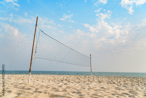 empty volleyball net on the tropical beach with blue sky. beach sport.