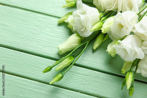 Bouquet of beautiful eustoma flowers on color wooden background  closeup