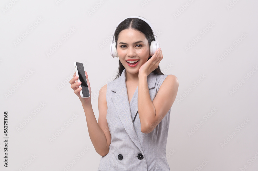 A young woman wearing headphones enjoying with music on white background A young woman wearing headphones enjoying with music on white background