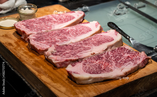 Fresh marbled wagyu beef  ribeye steak on wooden board.