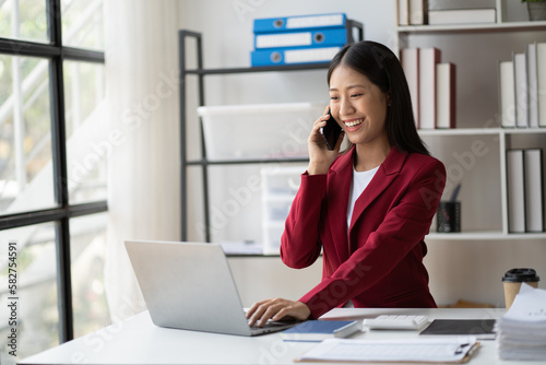 Asian business woman using smartphone in loft office