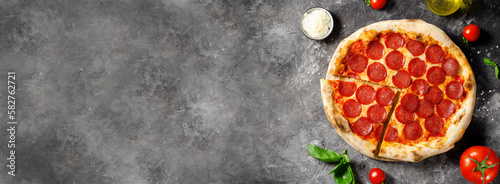 Pepperoni Pizza with Mozzarella Cheese, Salami, Tomato Sauce on Dark Background, Freshly Baked Pizza