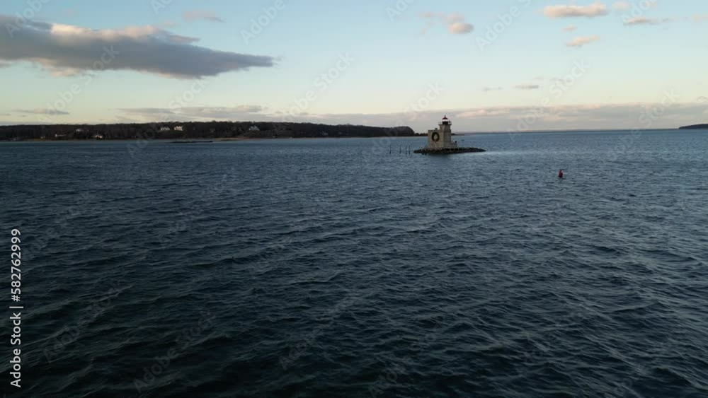 Drone view over a lighthouse in Huntington Harbor on Long Island in New York during a sunset Drone view over a lighthouse in Huntington Harbor on Long Island in New York during a sunset