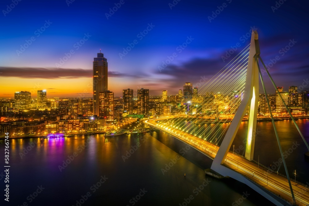 Fototapeta premium Scenic view of highrise buildings and city skyline with lights during dusk