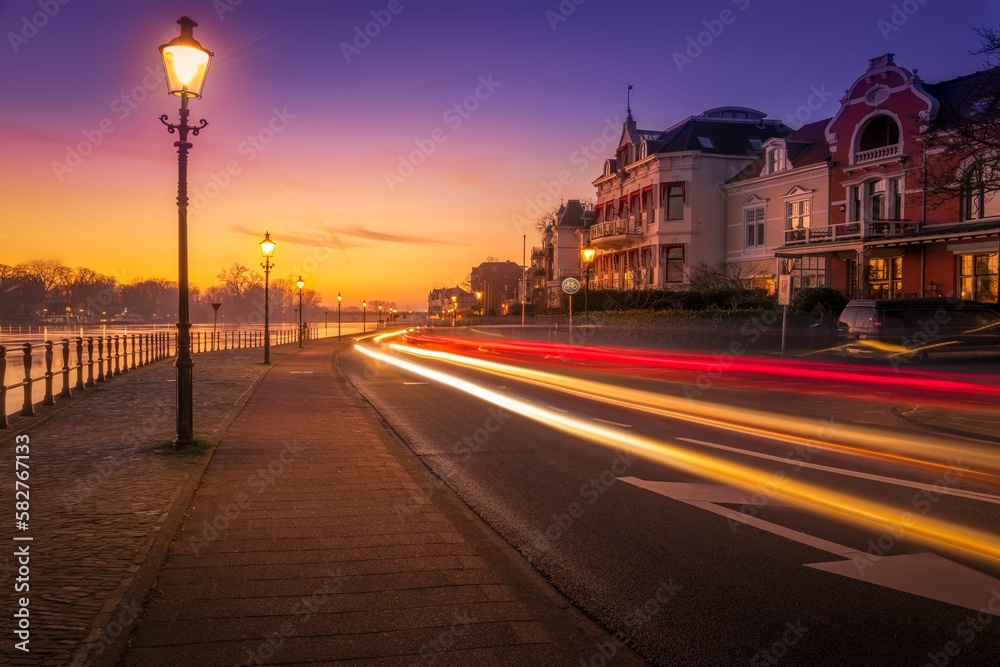 Long exposure of a busy street alongside a coast during sunset