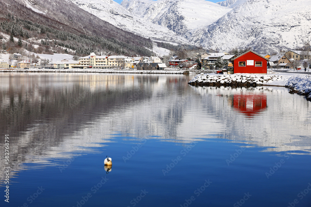 Fototapeta premium View of the village of Skei and lake Jolstravatnet, in Sunnfjord Municipality, Vestland county, Norway. Scenic landscape in winter, with reflections on the water. 