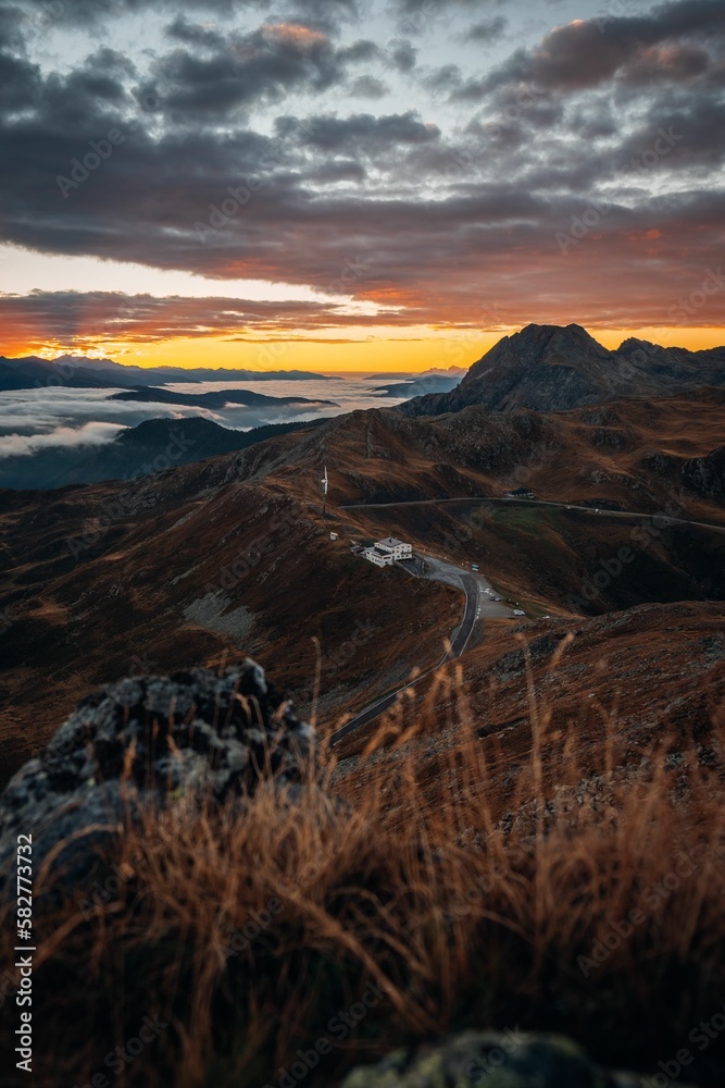 Road passing through beautiful mountains of South Tyrol during the sunset