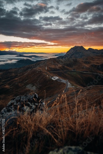 Road passing through beautiful mountains of South Tyrol during the sunset