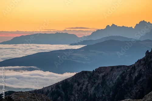 Silhouette of mountains covered by fog during the sunset in South Tyrol © Lukas Leitner/Wirestock Creators
