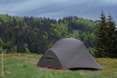 Tent on mountain col in grass in the morning. On background  Mala Fatra mountains  Slovakia.