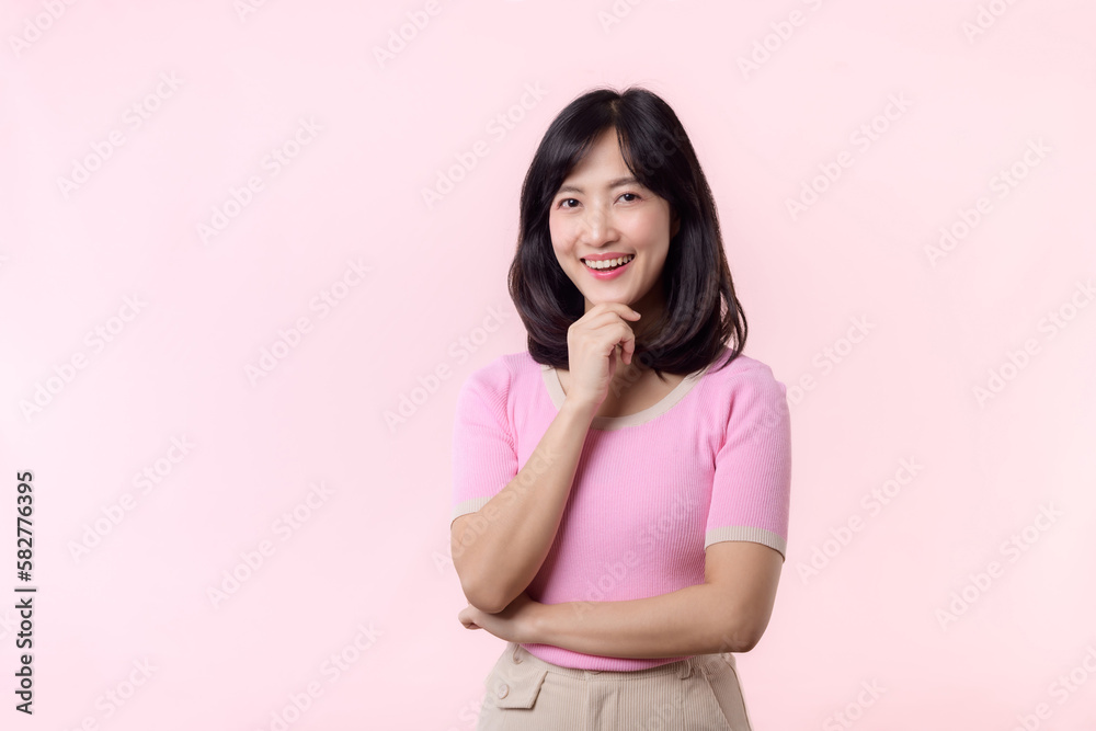 Portrait beautiful young asian woman thoughtful thinking an idea isolated on pink pastel background. Teenage female person pretty smile with thinking gesture concept. Portrait beautiful young asian woman thoughtful thinking an idea isolated on pink pastel background. Teenage female person pretty smile with thinking gesture concept.