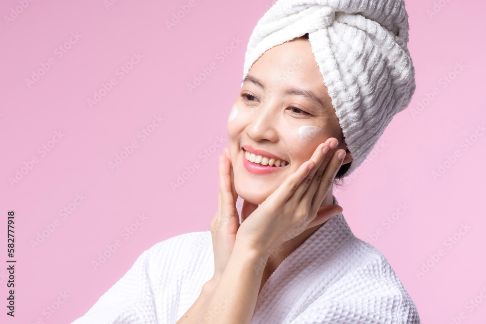 Young asian woman applying facial skincare face cream, cosmetic moisturiser on healthy natural skin make up face. Portrait glowing smile girl person model with care beauty product, spa, cosmetology. Young asian woman applying facial skincare face cream, cosmetic moisturiser on healthy natural skin make up face. Portrait glowing smile girl person model with care beauty product, spa, cosmetology.