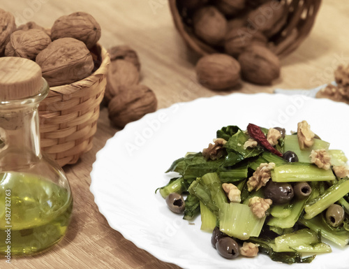 chicory catalogna with walnuts and olives photo