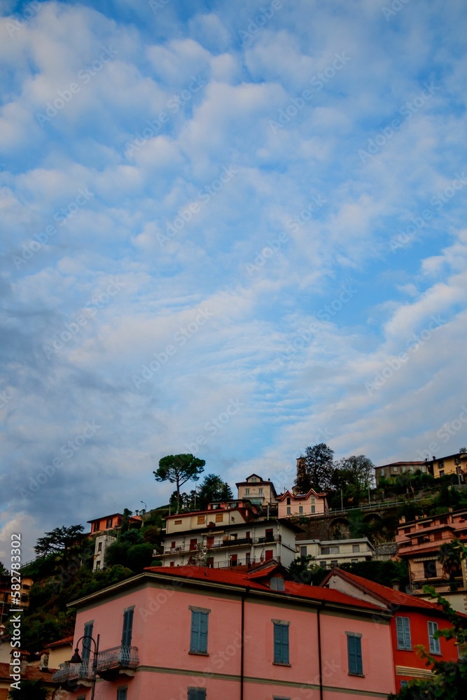 Vertical shot of cloudy morning on the buildings of Argegno in Italy