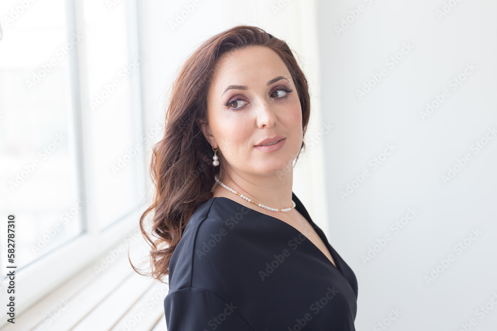 Beautiful woman portrait with stylish pearl earrings and necklaces accessories, closeup. Jewelry and handmade jewellery concept Beautiful woman portrait with stylish pearl earrings and necklaces accessories, closeup. Jewelry and handmade jewellery concept