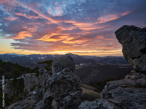 sunset in the mountains with rocks and impressive clouds