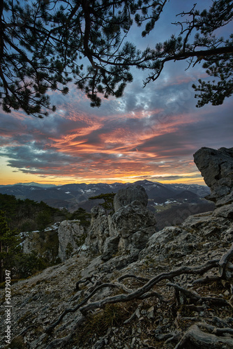 sunset in the mountains with rocks and impressive clouds