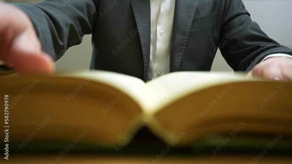 End face of book. Businessman flipping page
End face of book. Businessman flipping page