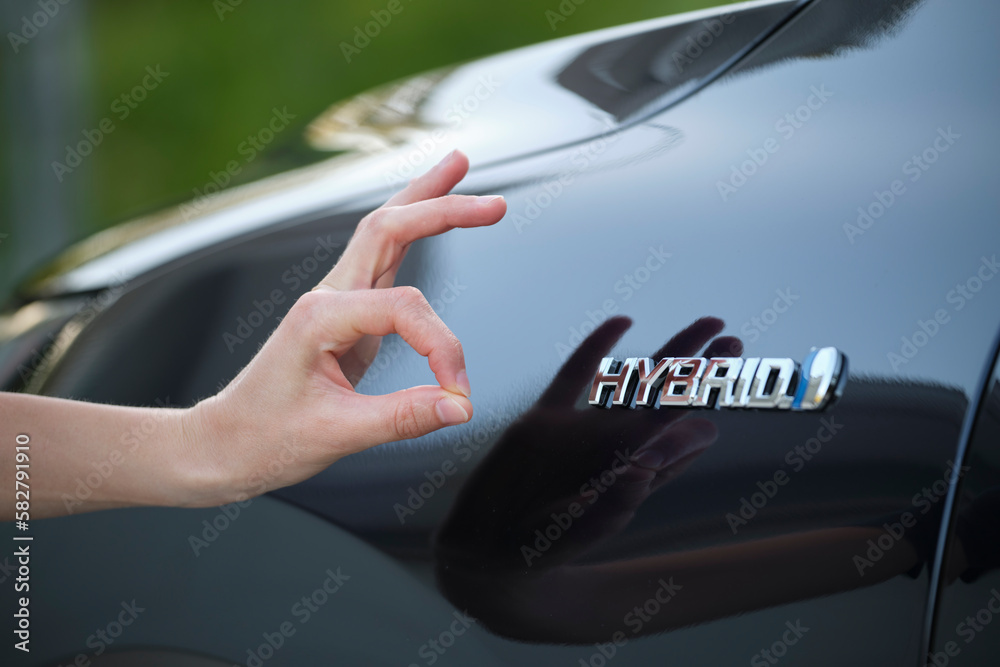 Purchaser hand showing thumb up sign at hybrid car new effective vehicle - obrazy, fototapety, plakaty 