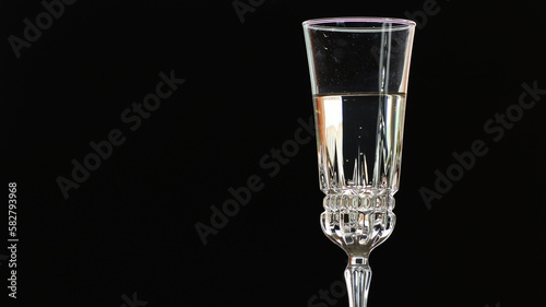 On a holiday, champagne is poured into a crystal glass.